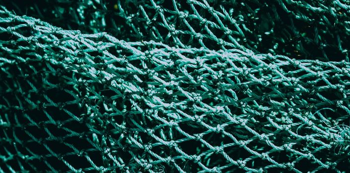 BANNER abstract close-up macro real photo beautiful wallpaper. Fisherman rope net texture fiber surface pattern. Sea blue green light colour. Futuristic subtle waving lines art modern Dark background