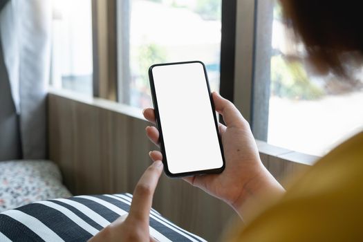 cell phone blank white screen mockup.woman hand holding texting using mobile at cafe. background empty space for advertise.work people contact marketing business,technology