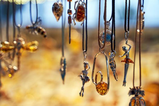 Sopot, Poland, Oct 5, 2018: Amber jewelry pendants displayed on a shopfront in the city center.