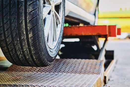 Replacing a car wheel at a tire station. a rubber covering, typically inflated or surrounding an inflated inner tube, placed around a wheel to form a flexible contact with the road.