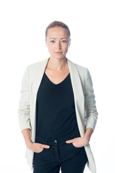 Full body portrait of casualy dressed,cheerful, beautiful, smart, young businesswoman in standing against white background hands in black jeans pockets.