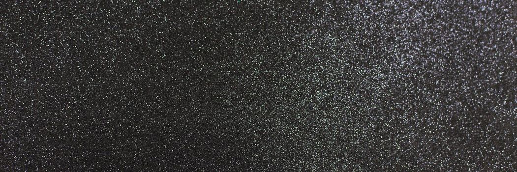 Black shiny background with sparkles. Dark gray abstract festive background. Web banner.