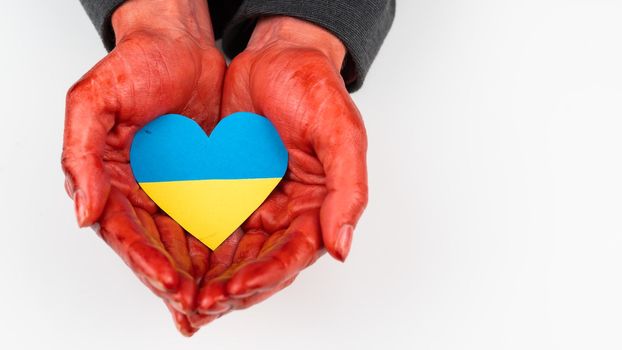 Woman with hands covered in blood holding a heart with the flag of ukraine on a white background