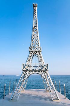 a copy of the Paris Eiffel tower on the seashore. High quality photo