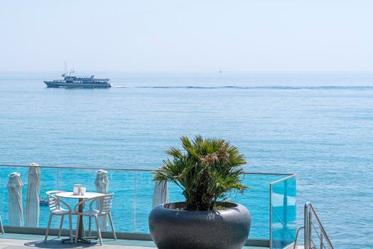 cafe tables on the embankment with a sea view. High quality photo