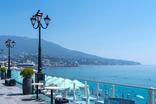 cafe tables on the embankment with a sea view. High quality photo