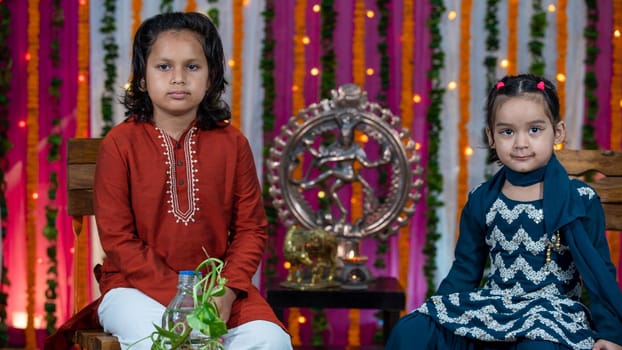 Indian children wearing ethnic Indian dress during Raksha Bandhan, a festival to celebrate the bond between brother-sister. Decoration in Indian houses.