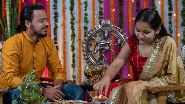 Indian families celebrating Raksha Bandhan festival a festival to celebrate the bond between brother and sister. Rakhi celebration in India. Feeding sweets, applying tikka.