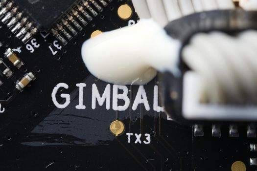 Super macro close up of gimbal area on an electronic drone circuit board. Modern technology and components, these drive a camera stabilization device.