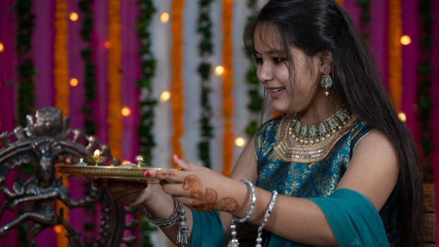 Indian families celebrating Raksha Bandhan festival a festival to celebrate the bond between brother and sister. Rakhi celebration in India. Feeding sweets, applying tikka.