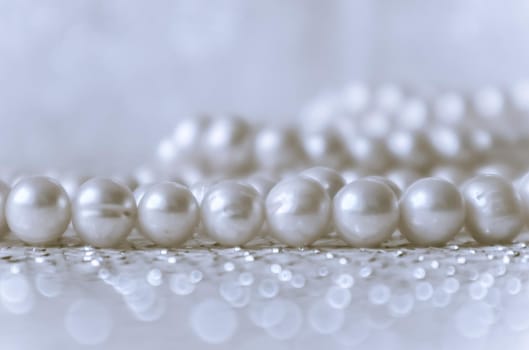 Nature white pearl beads on sparkling background