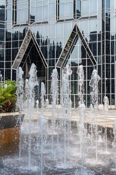 Frozen water from fountain in front of reflective office building in downtown Pittsburgh