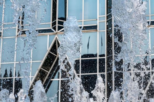 Frozen water from fountain in front of reflective office building in downtown Pittsburgh