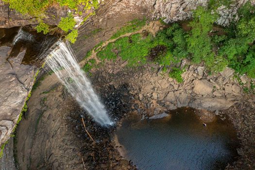 Water flowing over the cliff edge at Ozone falls in Tennessee as the water flows into the pool below