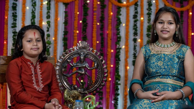 Indian children wearing ethnic Indian dress during Raksha Bandhan, a festival to celebrate the bond between brother-sister. Decoration in Indian houses.