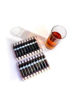 Group object of liquid medicinal agent in limpid glassware in medical laboratory. Group of ampoules with a transparent medicine in medical laboratory. horizontal perspective view of many brown ampoules set in pharmaceutical packaging white container
