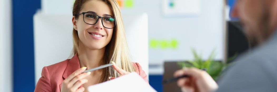 Portrait of cheerful optimistic woman listen to colleague report, office worker in suit. Woman boss proud of her worker. Business, career, strategy concept