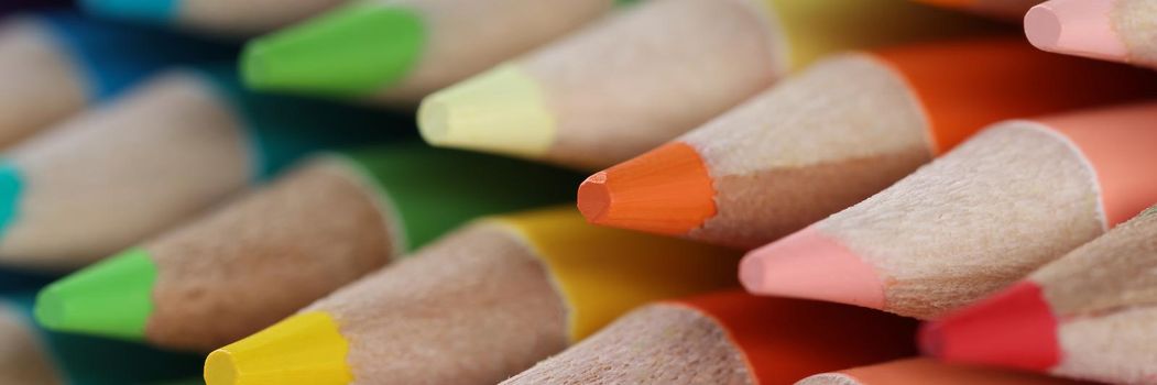 Close-up of sharpened colourful pencil set for painting forming stack. Pigmented crayons for drawing on paper. Vision, imagination, creativity, art concept