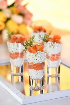 Verrine  from soft cheese cream and salmon, dill sprig and lemon slice. Aperitif appetizer.