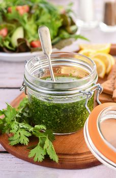 Green tasty herb sauce marinade from cilantro, parsley, oil, traditional seasoning for salad dressing