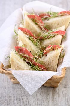 Wheat toast sandwich with cream cheese with microgreen alfalfa sprouts and salami. Healthy and fresh food.