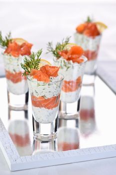 Verrine  from soft cheese cream and salmon, dill sprig and lemon slice. Aperitif appetizer.