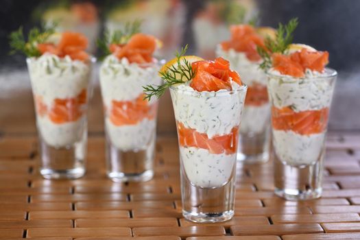  Verrine  from soft cheese cream and salmon, dill sprig and lemon slice. Aperitif appetizer.