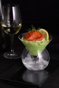 Taste is a combination of avocado pulp with a delicate texture of soft  cheese cream and salmon, with the addition of dill and a slice of lemon. Serving verrine in a Martini Chiller with ice. Aperitif appetizer