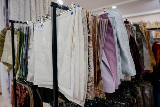 A row of colorful pillowcases on a shelf in a textile store.Many colorful pillowcases are sold in the shopping center