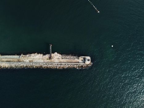 Aerial drone view of a breakwater. breakwater in the sea, a collection of concrete breakers. sea pier. High quality 4k footage