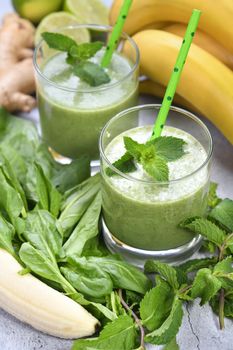 Fresh organic detox green drink smoothie with spinach, banana, lime and ginger with refreshing mint. Healthy, dietary, vegetarian food