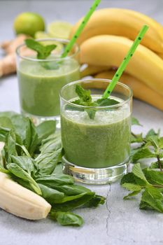 Fresh organic detox green drink smoothie with spinach, banana, lime and ginger with refreshing mint. Healthy, dietary, vegetarian food