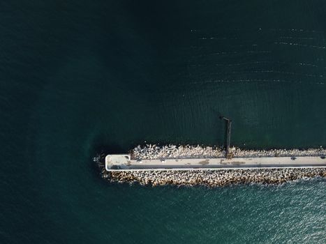 Aerial drone view of a breakwater. breakwater in the sea, a collection of concrete breakers. sea pier. High quality 4k footage