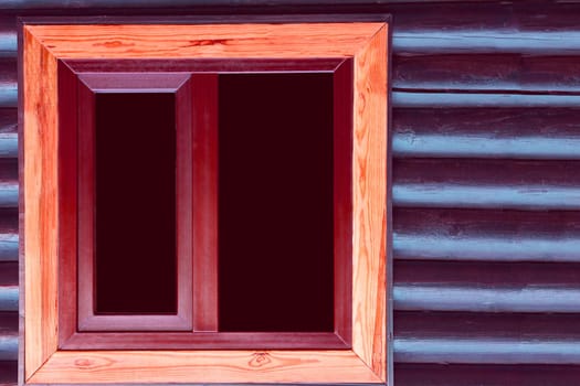 an opening in the wall of a building or vehicle that is fitted with glass or other transparent material in a frame.Black window in a wooden brown frame in a wooden wall of blue brown logs timbers.