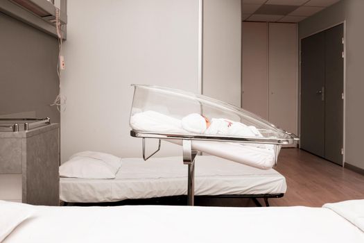 Newborn baby sleeping in a hospital bed