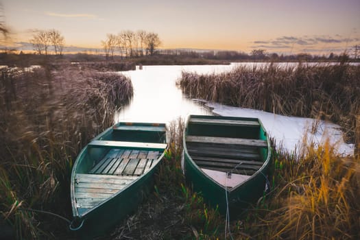 Two boats on the shore of the lake, evening view