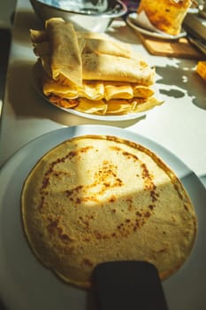Pancakes on a plate on the kitchen counter, food preparation
