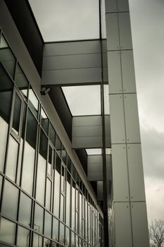 Glass facade and structure of a modern building, cloudy day