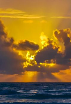 Amazing beautiful golden yellow colorful sunrise sunset with sunbeams at tropical beach with panorama view in Tulum Quintana Roo Mexico.
