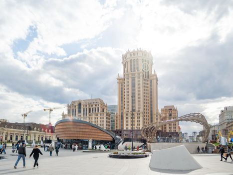 MOSCOW, RUSSIA - May 01, 2022. Local people and tourists walk on square near Paveletsky railway. Modern urban architecture.