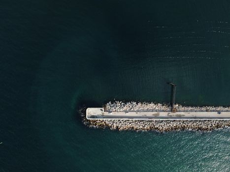 Aerial drone view of a breakwater. breakwater in the sea, a collection of concrete breakers. sea pier. High quality 4k footage