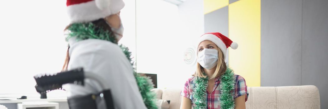 Portrait of visit friend in hospital room, relative in wheelchair, face mask for protection. Healthcare, medicine, disabled people, nursing house concept