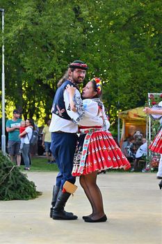 Brno - Bystrc, Czech Republic, June 25, 2022.  Traditional Czech feast. Folk Festival. Girls and boys dancing in beautiful costumes. An old Christian holiday, a day of abundance, joy and prosperity.