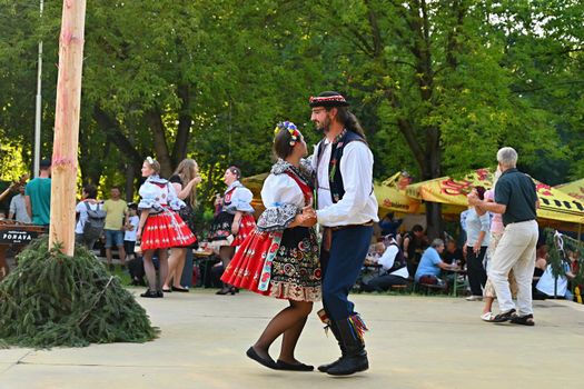 Brno - Bystrc, Czech Republic, June 25, 2022.  Traditional Czech feast. Folk Festival. Girls and boys dancing in beautiful costumes. An old Christian holiday, a day of abundance, joy and prosperity.