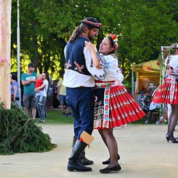 Brno - Bystrc, Czech Republic, June 25, 2022.  Traditional Czech feast. Folk Festival. Girls and boys dancing in beautiful costumes. An old Christian holiday, a day of abundance, joy and prosperity.