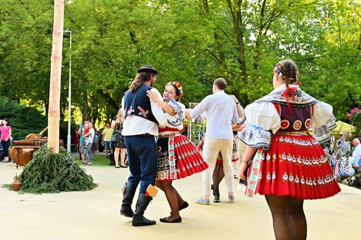 Brno - Bystrc, Czech Republic, June 25, 2022.  Traditional Czech feast. Folk Festival. Girls and boys dancing in beautiful costumes. An old Christian holiday, a day of abundance, joy and prosperity.