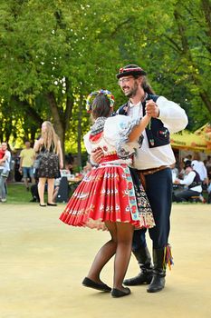 Brno - Bystrc, Czech Republic, June 25, 2022.  Traditional Czech feast. Folk Festival. Girls and boys dancing in beautiful costumes. An old Christian holiday, a day of abundance, joy and prosperity.