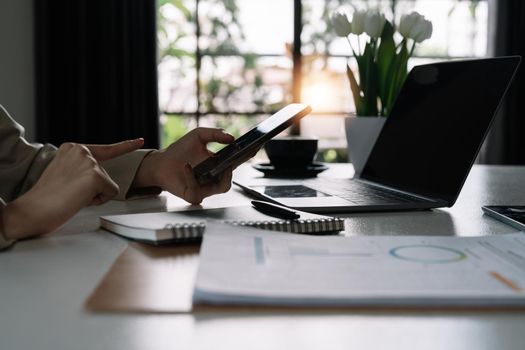 Modern workplace cloae up businesswoman using mobile phone in office