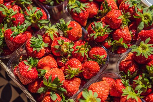 wooden box full of fresh organic strawberries on white background. top view.