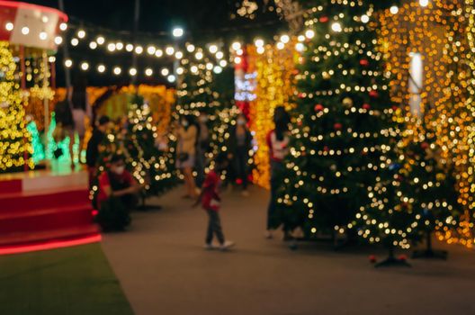 Blur Festival people Christmas abstract background. New year and Christmas party decorations with lights.